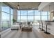 Bright living room featuring floor to ceiling windows with city views and modern furnishings at 1700 Bassett St # 1106, Denver, CO 80202