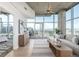 Bright living room with city views from floor-to-ceiling windows, complemented by a comfortable seating area and a neutral color palette at 1700 Bassett St # 1106, Denver, CO 80202