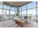 Cozy living room boasts a comfortable couch, city views, and natural light from large windows at 1700 Bassett St # 1106, Denver, CO 80202