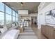 Open-concept living area with modern kitchen, stylish furnishings, and floor-to-ceiling windows offering city views at 1700 Bassett St # 1106, Denver, CO 80202