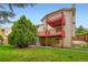 Exterior view of a home featuring a lawn and tiered wooden deck at 9670 W 70Th Ave, Arvada, CO 80004