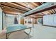 Spacious unfinished basement with exposed ceiling and ping pong table at 9670 W 70Th Ave, Arvada, CO 80004