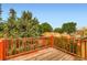 View from a wood deck overlooking mature trees and neighboring rooftops at 9670 W 70Th Ave, Arvada, CO 80004