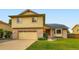 Two-story home with attached garage and manicured lawn at 9670 W 70Th Ave, Arvada, CO 80004