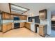 Kitchen with oak cabinets, light countertops and a range of essential appliances at 9670 W 70Th Ave, Arvada, CO 80004
