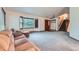 Spacious living room with bay window, comfortable seating, and staircase access at 9670 W 70Th Ave, Arvada, CO 80004