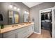 Contemporary bathroom featuring a double sink vanity, modern lighting, and walk-in closet at 4150 Longview Ln, Boulder, CO 80301