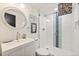 Modern bathroom featuring a sleek vanity, decorative mirror, and glass-enclosed shower with stylish tile at 4150 Longview Ln, Boulder, CO 80301