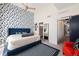 Bedroom with blue accent wall, ensuite bathroom, and a walk in closet at 4150 Longview Ln, Boulder, CO 80301