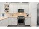 Kitchen featuring stainless steel appliances, white cabinets, and hardwood floors at 4150 Longview Ln, Boulder, CO 80301