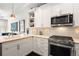 Kitchen featuring stainless steel appliances, white cabinets, and hardwood floors at 4150 Longview Ln, Boulder, CO 80301