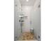 Modern glass shower with unique pebble flooring and built-in shelving at 4150 Longview Ln, Boulder, CO 80301