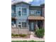 Charming townhouse with colorful exterior, covered entryway, and landscaped front yard with a picket fence at 4150 Longview Ln, Boulder, CO 80301