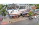 Aerial view of urban corner commercial building featuring outdoor seating and vibrant neighborhood at 1650 N Pennsylvania St, Denver, CO 80203