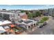 Aerial view of a vibrant neighborhood commercial area, featuring outdoor dining and mixed-use buildings at 1650 N Pennsylvania St, Denver, CO 80203