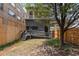Backyard featuring a deck, patio, fence, grass, and a mature tree at 1650 N Pennsylvania St, Denver, CO 80203