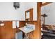 Vintage bathroom with wood paneling, a marble sink, and charming period details at 1650 N Pennsylvania St, Denver, CO 80203