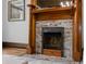 Close-up of a charming fireplace with decorative tile and a wooden mantel at 1650 N Pennsylvania St, Denver, CO 80203