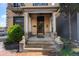 Elegant brick home featuring a covered front porch with classic columns and stately lion statues at 1650 N Pennsylvania St, Denver, CO 80203