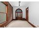 Hallway featuring an arched front door, exposed brick, natural light, and wood trim at 1650 N Pennsylvania St, Denver, CO 80203