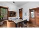 Well-lit home office with built-in cabinets, hardwood floors, and comfortable seating at 1650 N Pennsylvania St, Denver, CO 80203