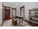 Bright office space featuring three windows, dark wood trim, and a minimalist aesthetic at 1650 N Pennsylvania St, Denver, CO 80203
