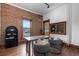 Functional home office with exposed brick, hardwood floors, and a built-in cabinet at 1650 N Pennsylvania St, Denver, CO 80203