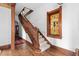 Grand wooden staircase with ornate details, complemented by a stained glass window and hardwood floors at 1650 N Pennsylvania St, Denver, CO 80203