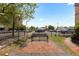 Street view showcasing a brick walkway, park bench, landscaping, and nearby buildings at 1650 N Pennsylvania St, Denver, CO 80203