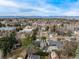 Expansive aerial shows neighborhood and distant mountains and city skyline at 374 Holly St, Denver, CO 80220