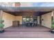 This home has a covered back porch with wood beams, a dining table, and a bar area at 374 Holly St, Denver, CO 80220