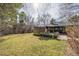 Landscaped backyard offers great outdoor living space with a stone patio and plush seating near the brick home at 374 Holly St, Denver, CO 80220