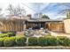 An outdoor patio with modern seating area is perfect for relaxation next to a brick house and manicured bushes at 374 Holly St, Denver, CO 80220