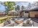 This home has a backyard with an outdoor living area, firepit, and patio at 374 Holly St, Denver, CO 80220