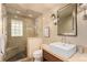 Modern bathroom featuring a tiled shower and stylish vanity at 374 Holly St, Denver, CO 80220
