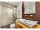 This bathroom has a vessel sink and an open shower with a glass wall at 374 Holly St, Denver, CO 80220
