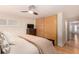 Cozy bedroom showcasing a king bed, modern closet, and warm hardwood flooring at 374 Holly St, Denver, CO 80220