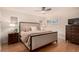 Comfortable bedroom with a king bed, dresser, and ample natural light, perfect for relaxation at 374 Holly St, Denver, CO 80220