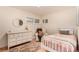 Cozy bedroom with chair and ample light at 374 Holly St, Denver, CO 80220