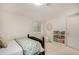 This is a bedroom with a bed, window and bookshelf in the basement at 374 Holly St, Denver, CO 80220