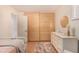 This bedroom has a walk-in closet with light colored wood sliding doors and a dresser at 374 Holly St, Denver, CO 80220