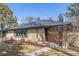 Brick ranch-style home featuring mature landscaping and a charming front entryway at 374 Holly St, Denver, CO 80220