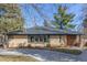 Well-maintained brick ranch-style home featuring updated windows and landscaping on a sunny day at 374 Holly St, Denver, CO 80220