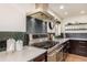 Close up on a kitchen featuring a stainless steel range and backsplash at 374 Holly St, Denver, CO 80220