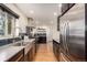 Modern kitchen featuring stainless steel appliances and dark cabinetry at 374 Holly St, Denver, CO 80220