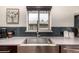 Modern kitchen sink with stylish backsplash, stainless steel faucet, and abundant counter space at 374 Holly St, Denver, CO 80220