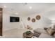 The basement living room features a decorative wooden wall and television at 374 Holly St, Denver, CO 80220