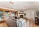 Sunlit living room with a cozy fireplace, sliding glass doors to backyard, and hardwood floors at 374 Holly St, Denver, CO 80220