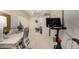 This home office features a desk and a work out area that leads to the living room at 374 Holly St, Denver, CO 80220