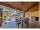 Inviting covered patio with an outdoor dining set, a grill, and a view of the landscaped backyard at 374 Holly St, Denver, CO 80220